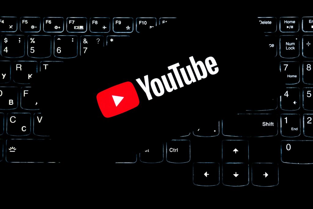 YouTube logo displayed on a backlit keyboard, representing digital media and online content creation.